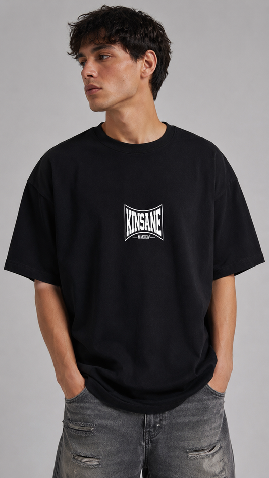Man wearing Black t shirt with white logo and text reading “KINSANE MMXXIV”