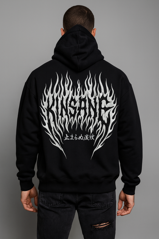 Back view of a man wearing a black hoodie with white flames and black lettering reading “KINSANE” and white Japanese lettering reading “UNSTOPPABLE WAVE”