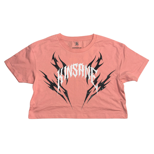 pink crop top T-shirt with black tribal designs and white lettering reading “KINSANE”