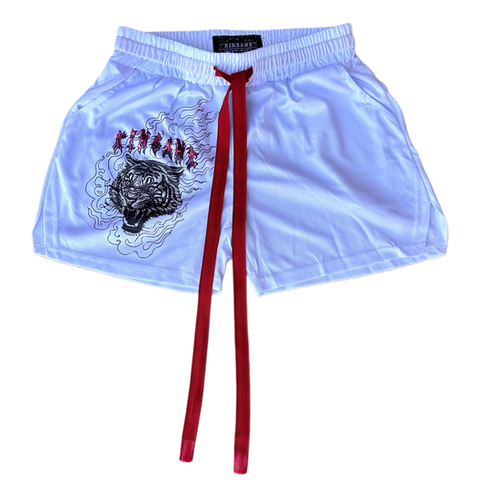 White athletic shorts with elastic waistband and red drawstrings with a tiger design in flames on the right leg and red lettering resembling “KINSANE”