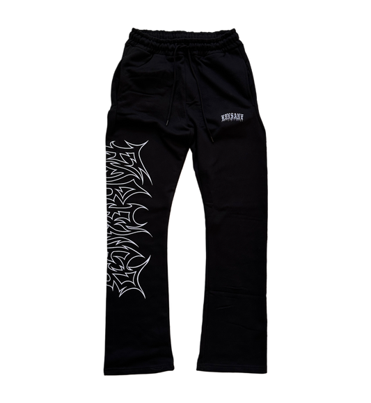black stacked sweatpants with white outlined tribal lettering reading “forever” on the left side and white old English style lettering reading “KINSANE” on the right side