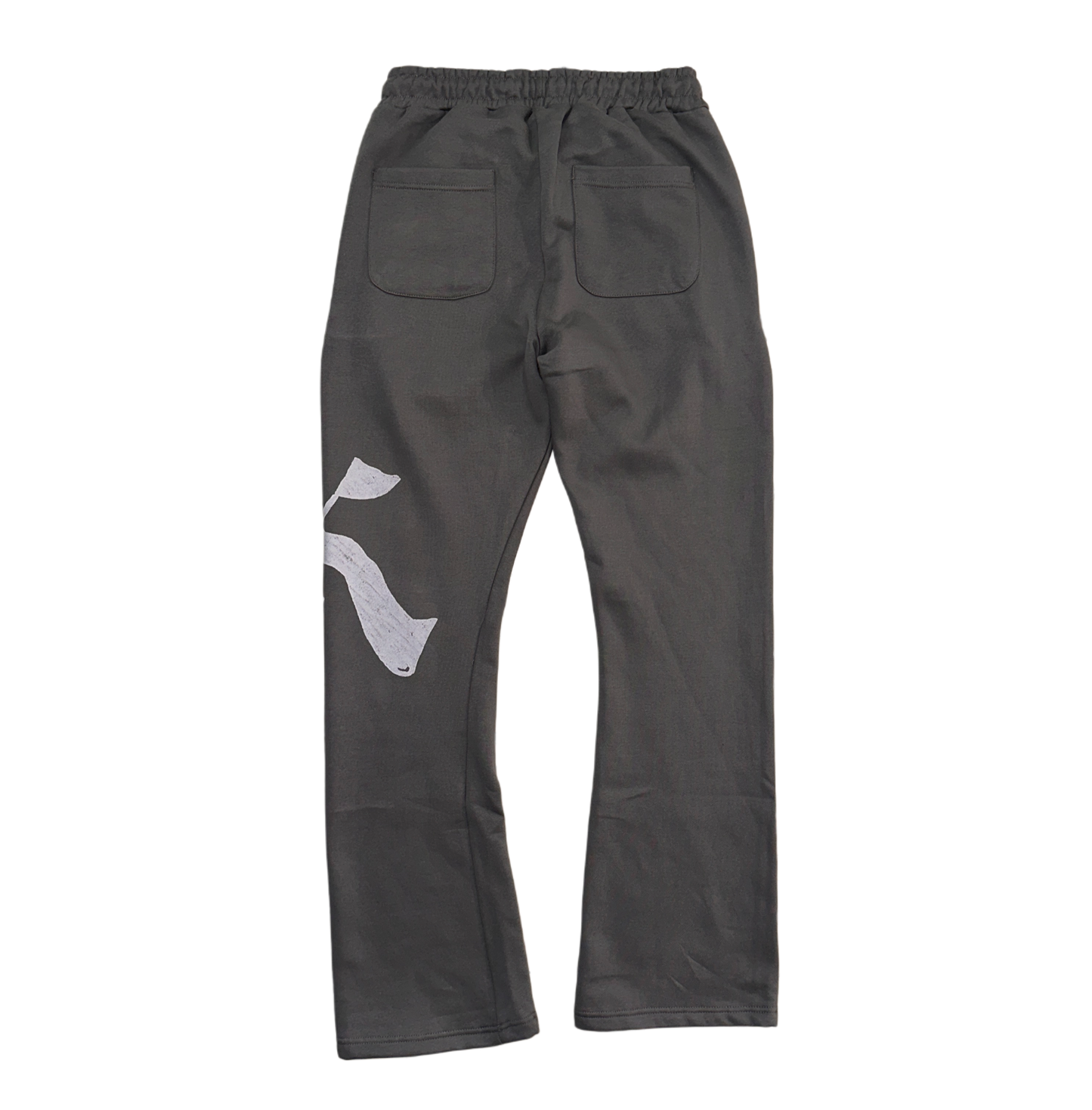 Back view of Gray stacked sweatpants with gray drawstrings and a white logo of a “K” on the left leg