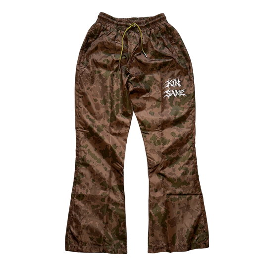 Brown camo sweatpants with green drawstrings and white text reading “KINSANE” on the left leg