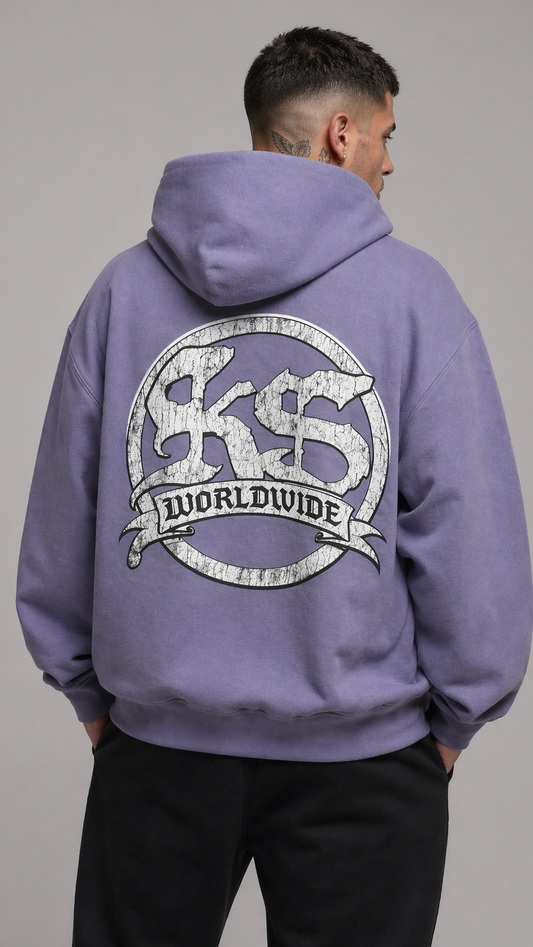 Back view of a man wearing a light blue hoodie with a white logo reading “KS WORLDWIDE”