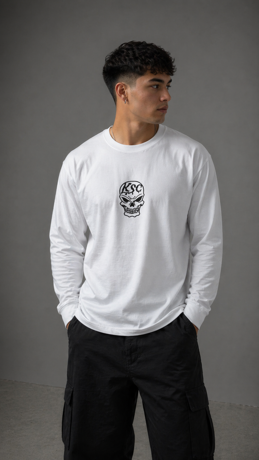 Man wearing White long sleeve shirt with black skull logo with black Text reading “KSC”