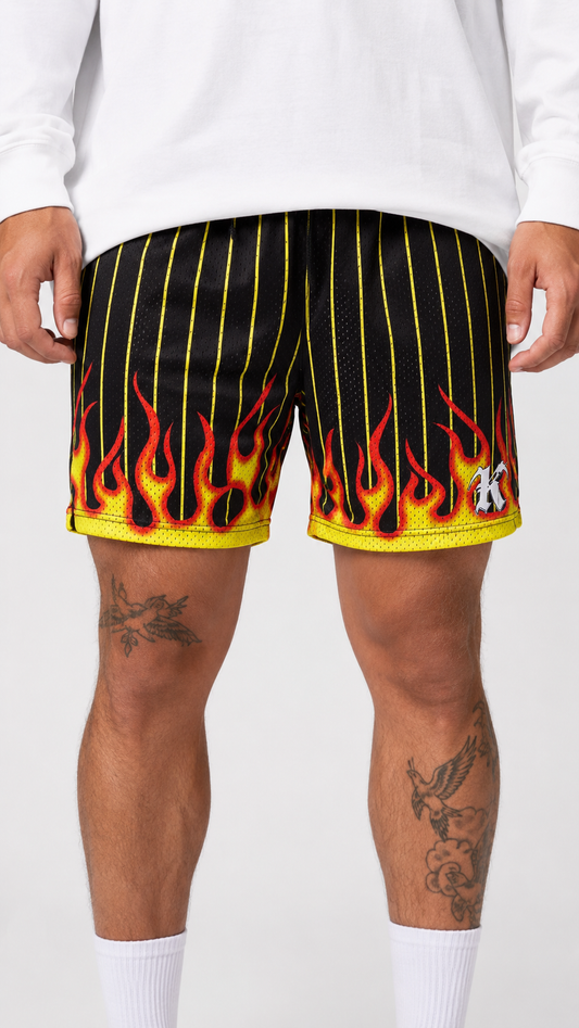 Man wearing Black and yellow shorts with flames design with a white “K” logo on the right side