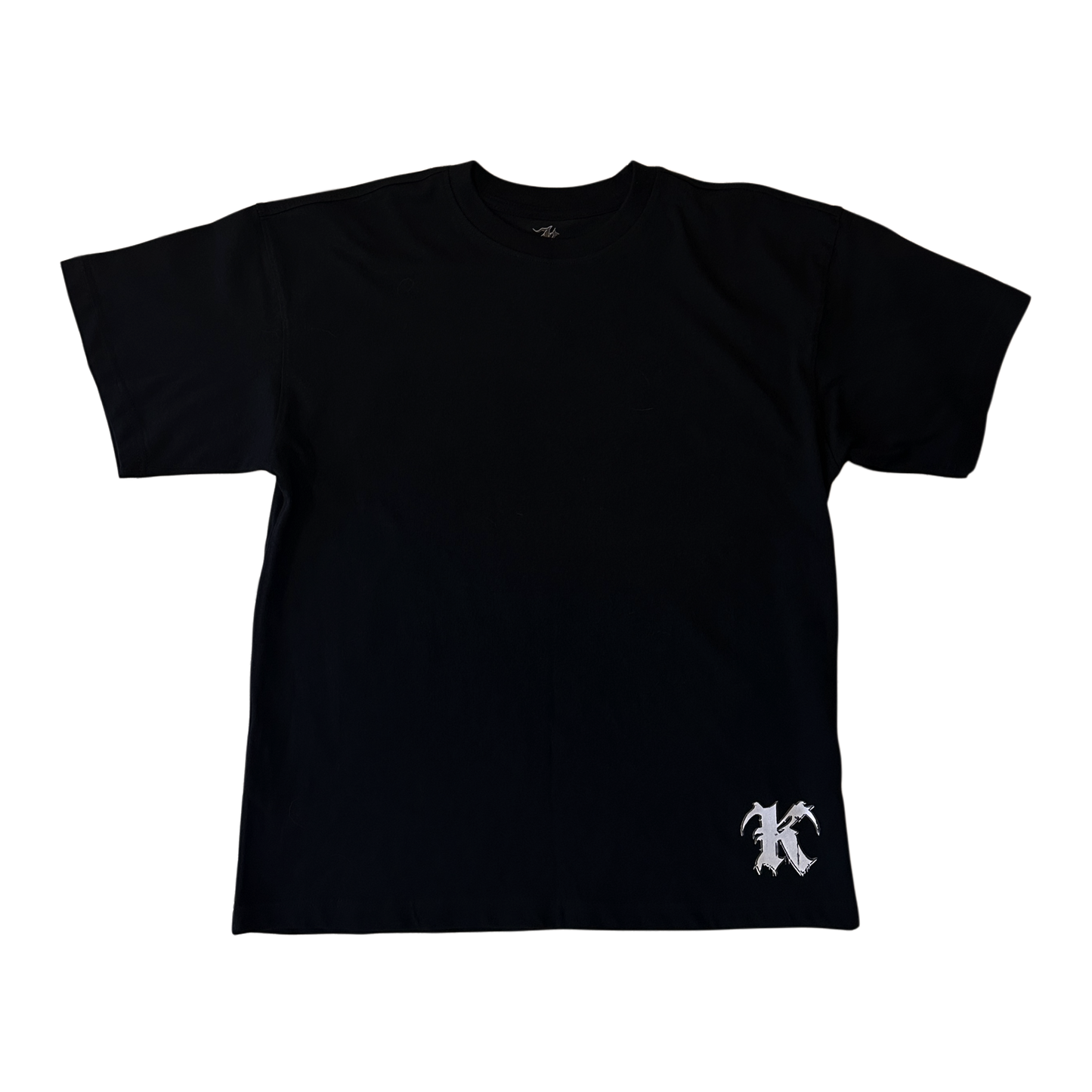 Black t shirt with white “K” logo at the bottom right corner