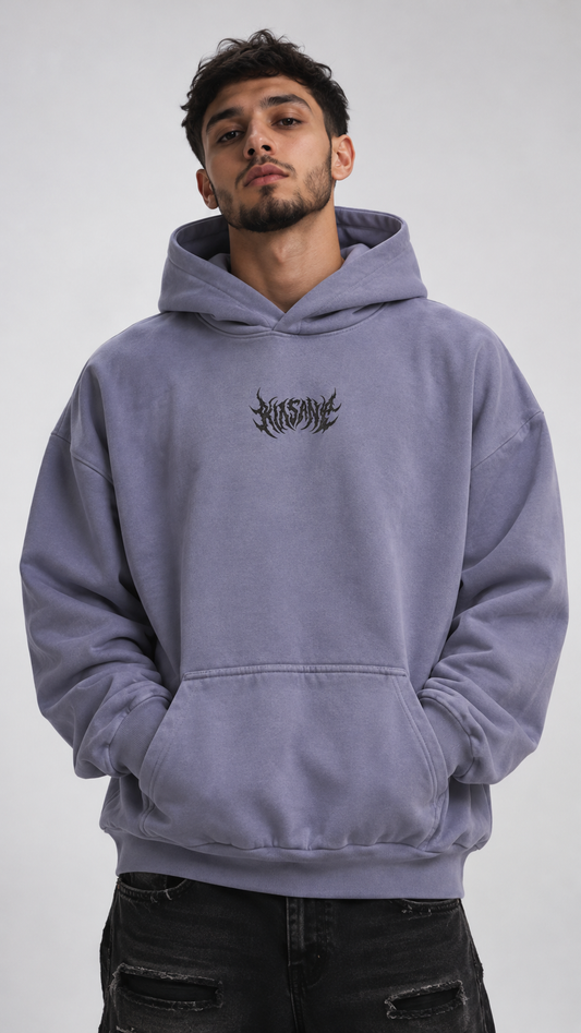 Man wearing a Light blue hoodie with black text in the center reading “KINSANE”
