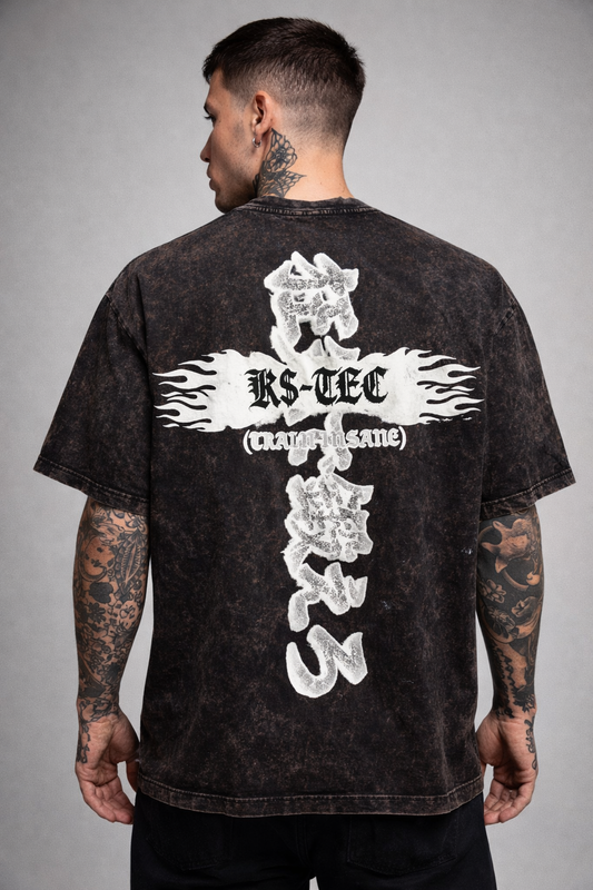 Back view of a man wearing a black acid washed t shirt with white logo on the back with white flames and black lettering reading “KS-TEC” and “(TRAIN INSANE)” and white Japanese lettering translating to “TRAIN INSANE”