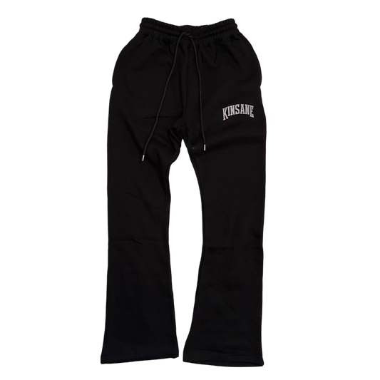 black stacked sweatpants with white lettering reading “KINSANE” on the right side 