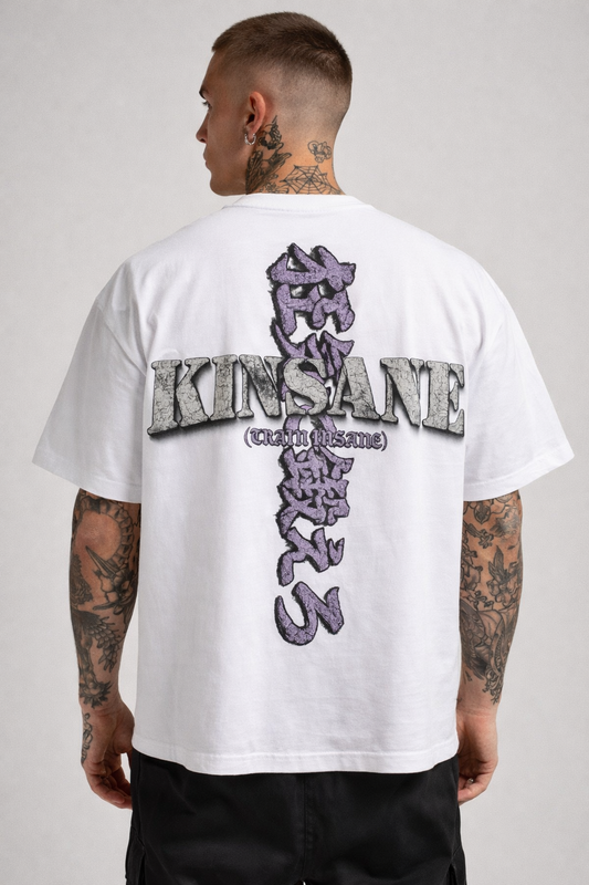Back view of a man wearing a white T-shirt with a logo with purple Japanese text translating to “TRAIN INSANE” and purple text reading “(TRAIN INSANE)” and grey text reading “KINSANE” 