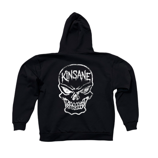 Back view of a black hoodie with a white skull design and white text reading “KINSANE” 