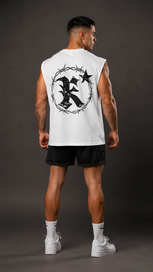 Back view of a man wearing a white sleeveless shirt with black barbed wire logo and letter “K”