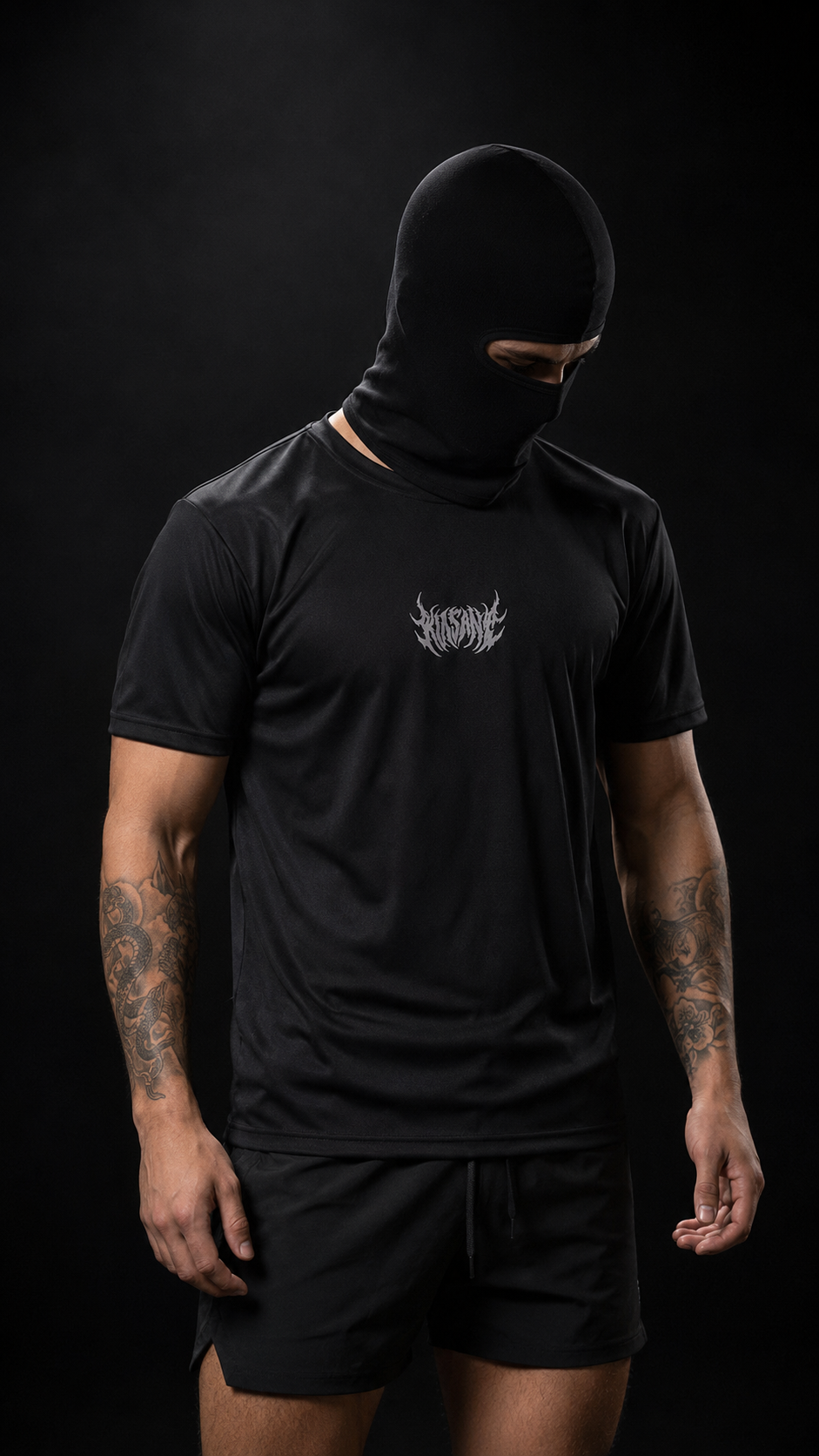 Man wearing Black dry fit t shirt with white text logo reading “KINSANE” on the chest 
