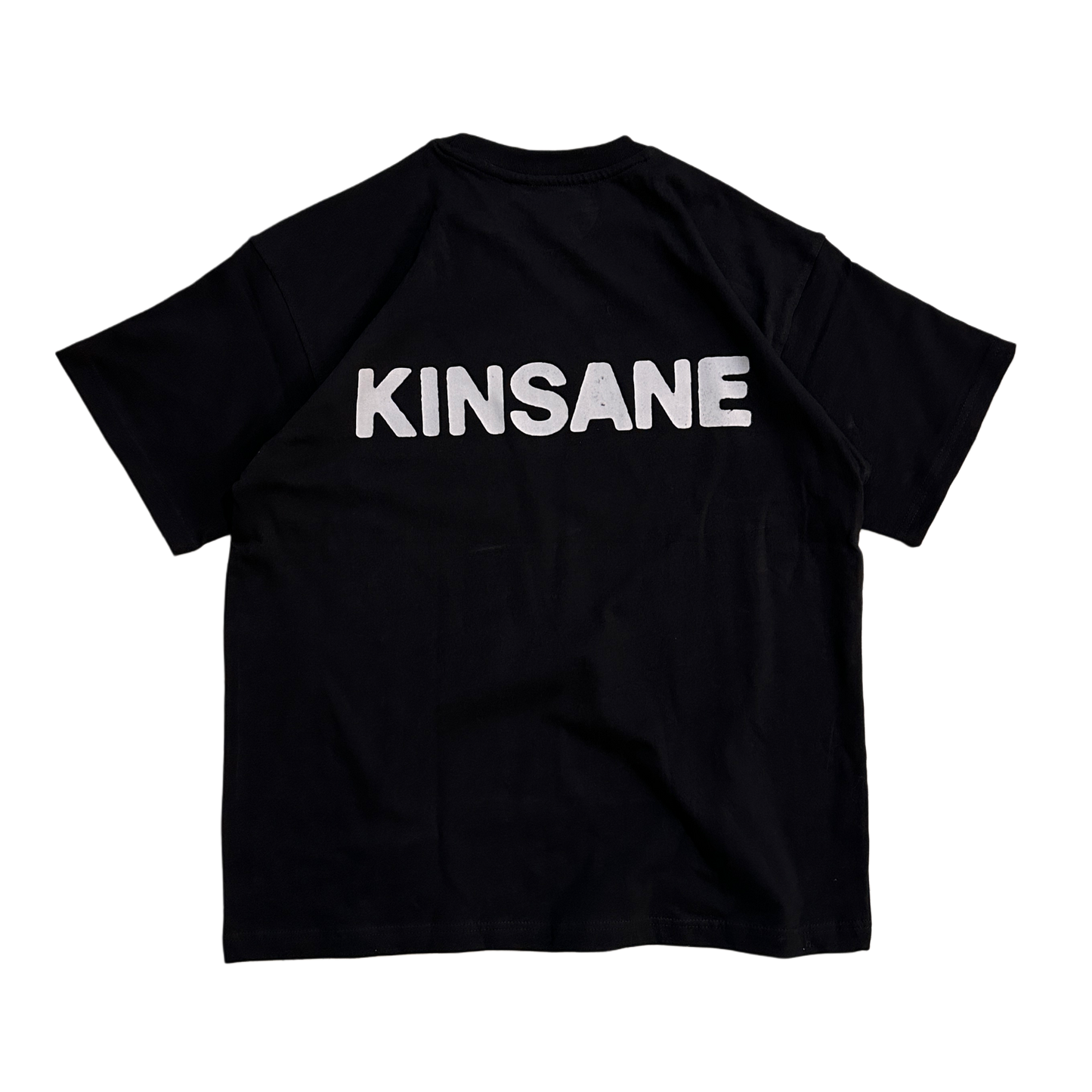 Back view of a black T-shirt with white text reading “KINSANE” 