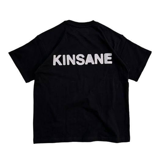 Back view of a black T-shirt with white text reading “KINSANE” 