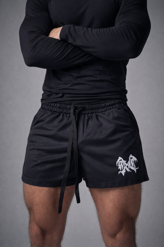 person with black shirt wearing black athletic shorts with elastic waistband, drawstrings, and white graphic logo on right leg