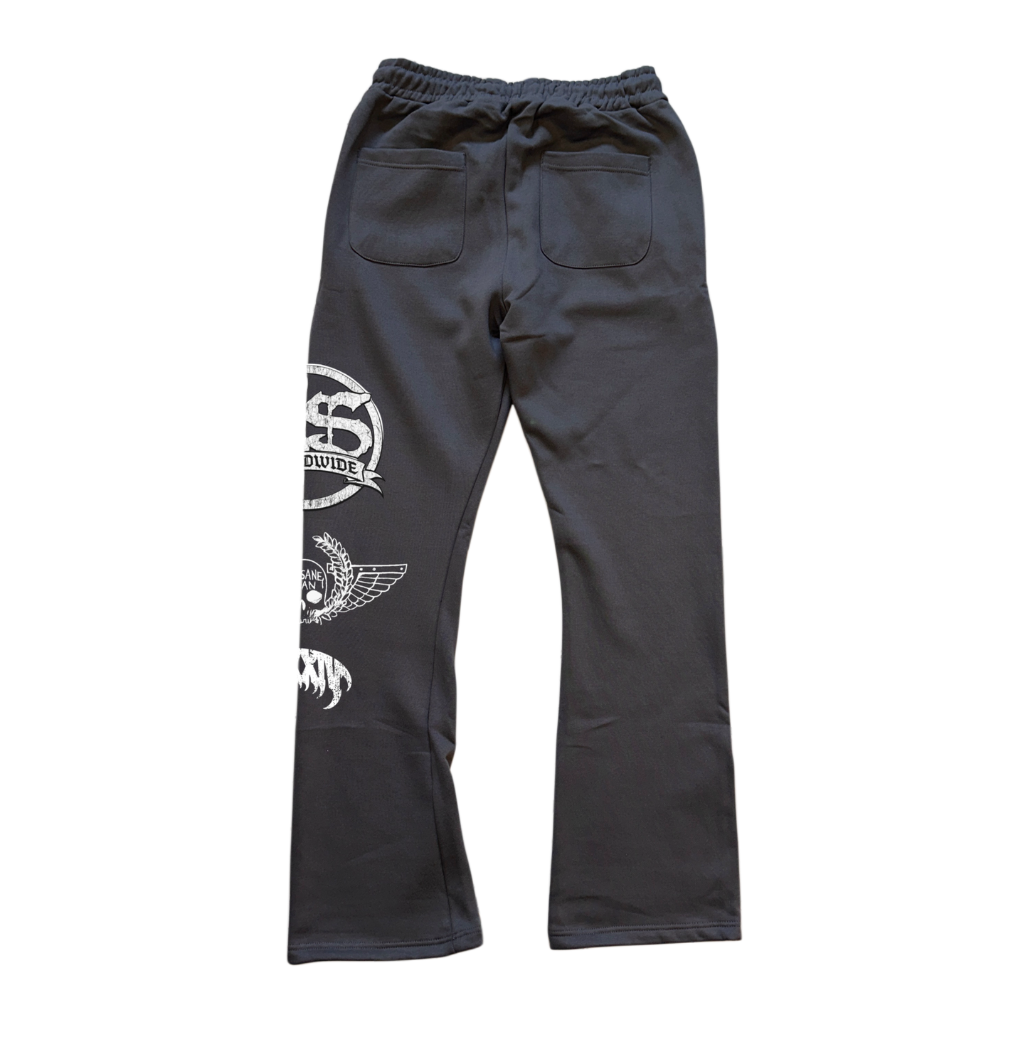 Back view of Gray stacked sweatpants white logos stacked on top of each other on the left leg that say “KS WORLDWIDE, MMXXIV” 