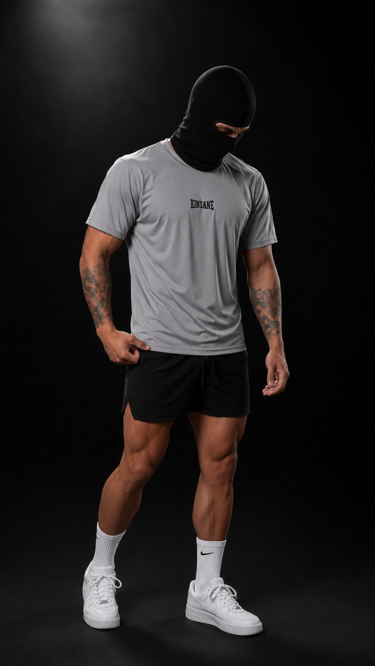 Man wearing Gray dry fit t shirt with dark blue lettering reading “KINSANE” 