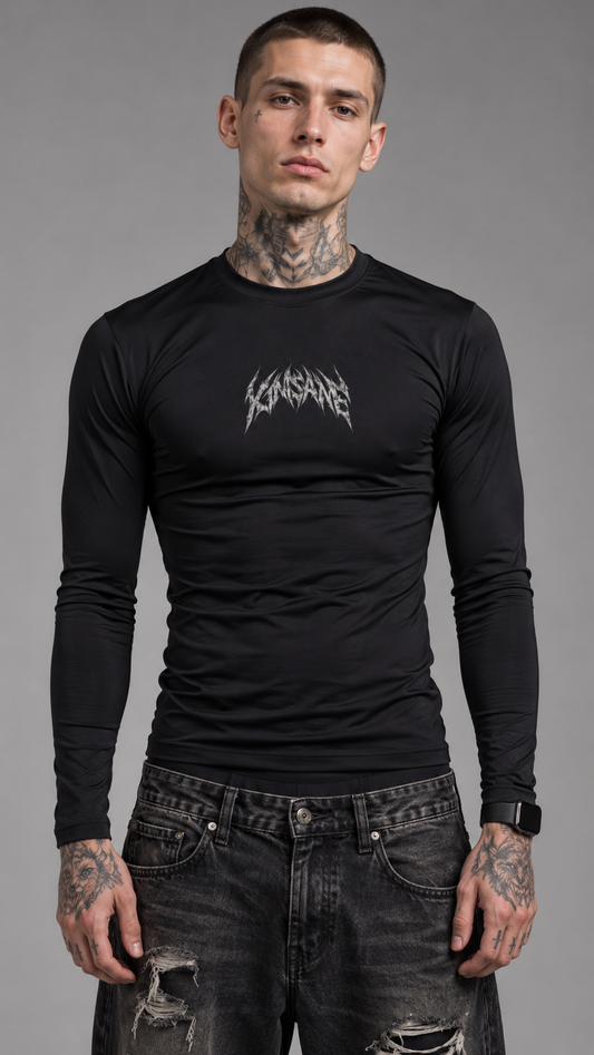 Man wearing Black long sleeve compression shirt with light gray / white text printed on the chest area reading “KINSANE” 