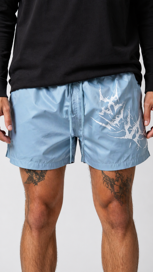 Man wearing Light blue shorts with light blue drawstrings and white lettering on the left leg reading “KINSANE”