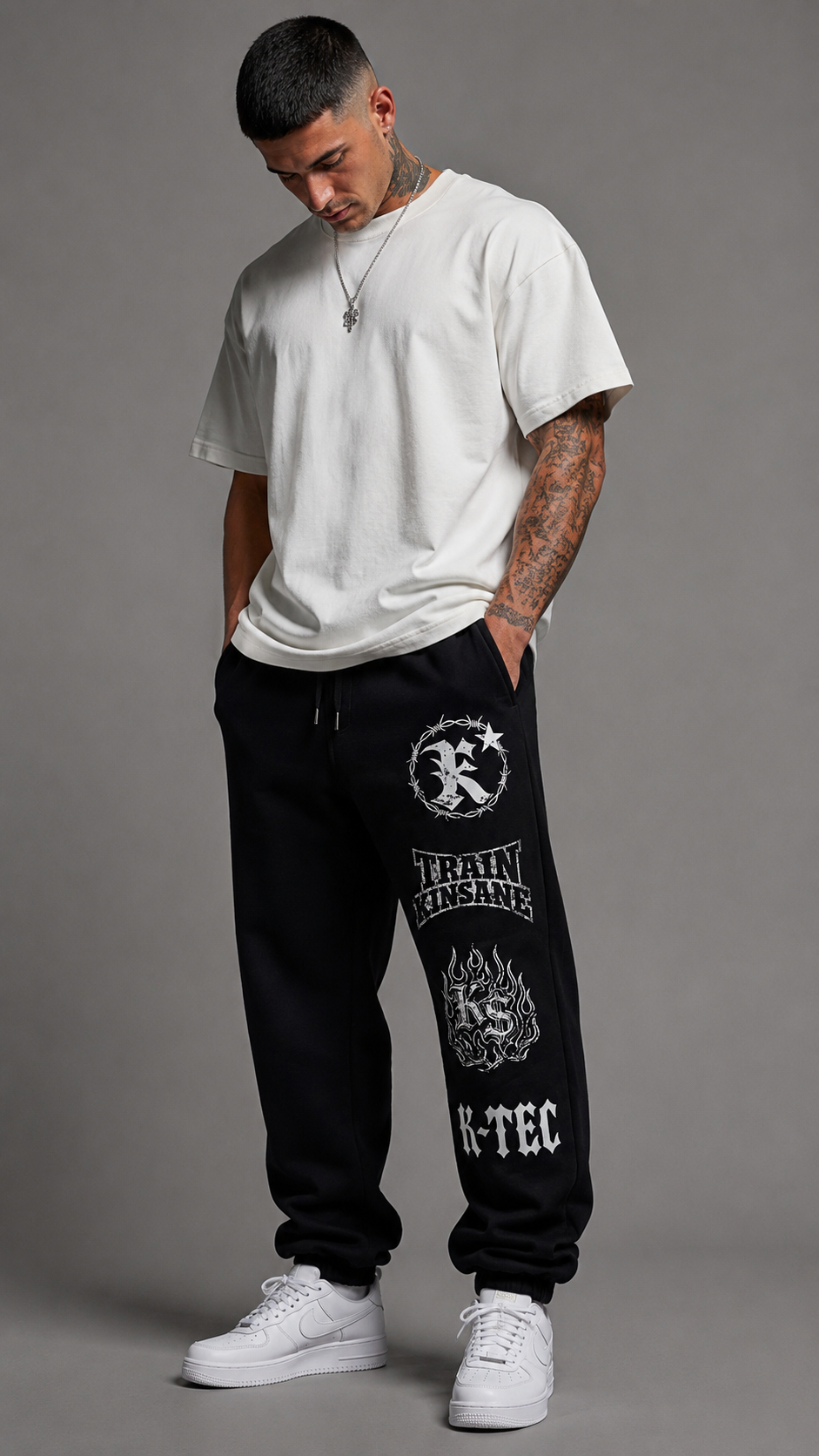 Man wearing black sweatpants with 4 white logos stacked on the right side 