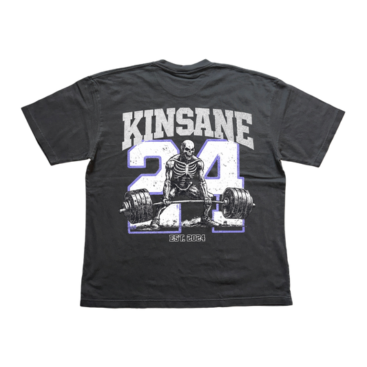 Back view of gray t shirt with white logo of a skeleton lifting weights and blue outlined “24” and white text reading “KINSANE” and “est 2024” 