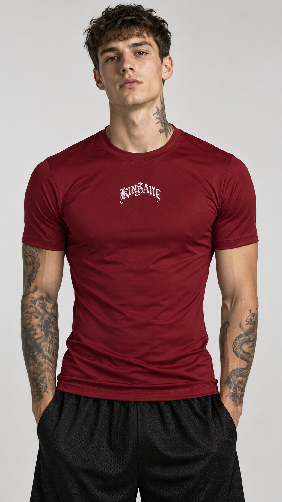 Man wearing Maroon dry fit shirt with white text reading “KINSANE” 