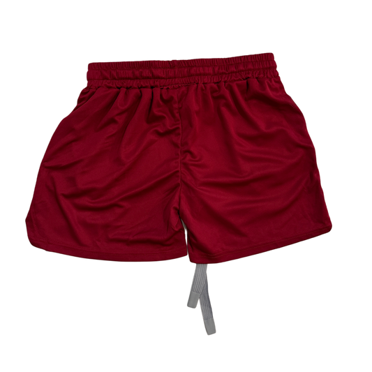 Back view of plain Dark red athletic shorts with elastic waists and, gray drawstrings. 