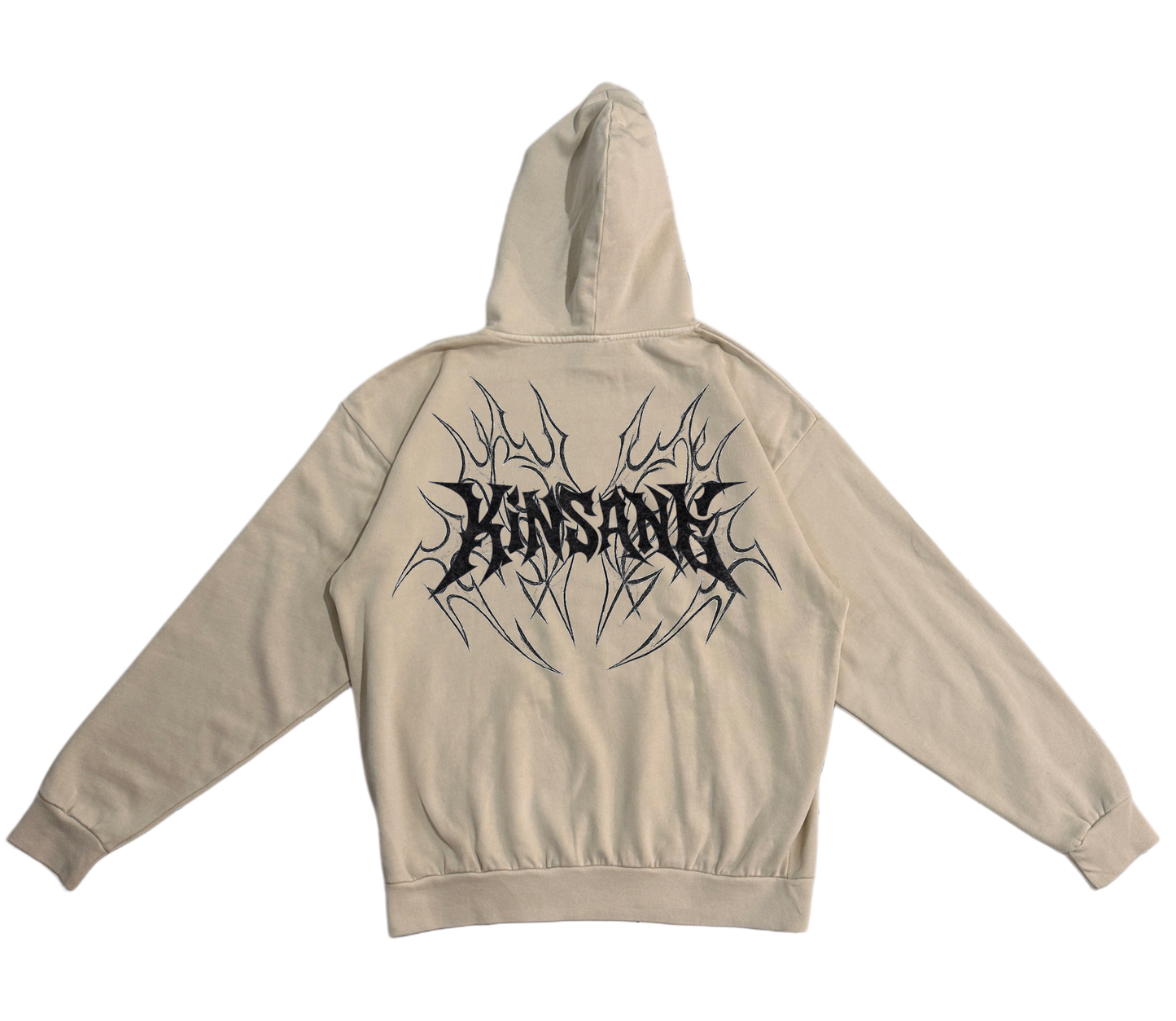 Back view of a beige hoodie with black tribal designs and black lettering reading “KINSANE” 