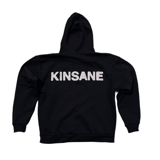 Back view of a black hoodie with white text reading “KINSANE” 