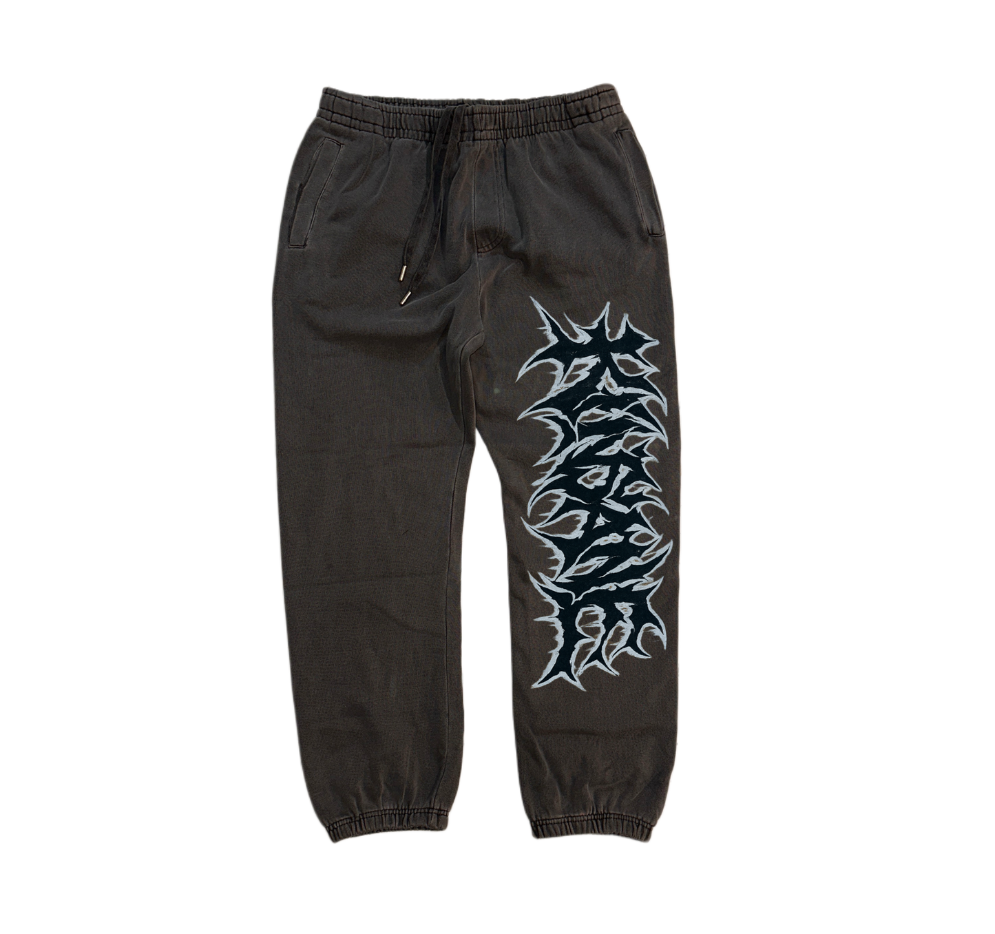 Grey cuffed joggers with black and white graffiti lettering reading “KINSANE” on the right side 