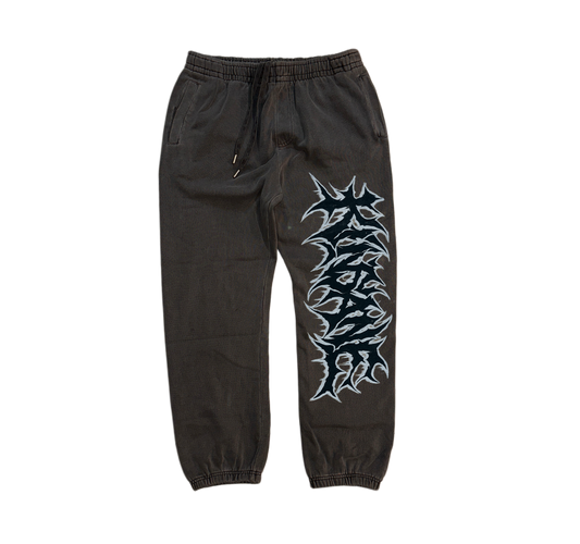 Grey cuffed joggers with black and white graffiti lettering reading “KINSANE” on the right side 