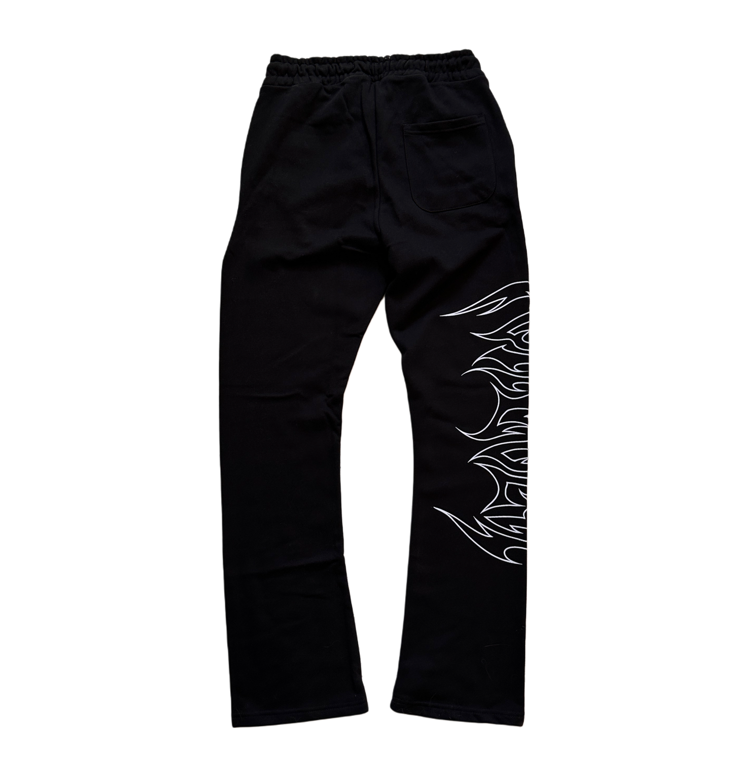 Back view of black stacked sweatpants with white outlined tribal lettering reading “forever” on the right side 