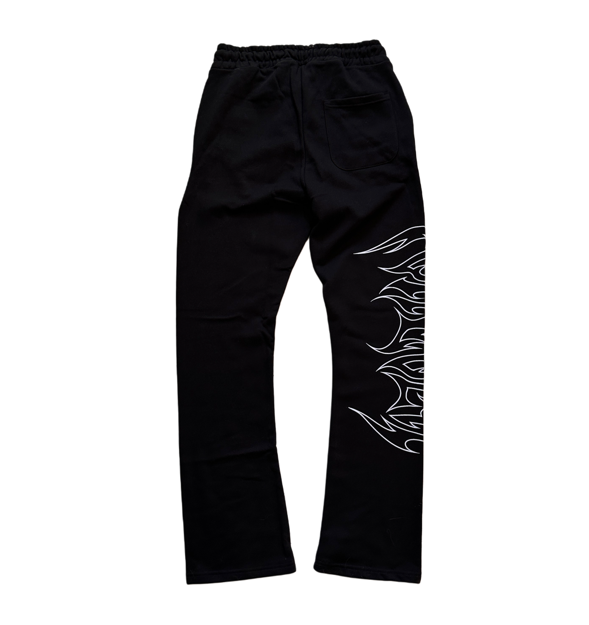Back view of black stacked sweatpants with white outlined tribal lettering reading “forever” on the right side 