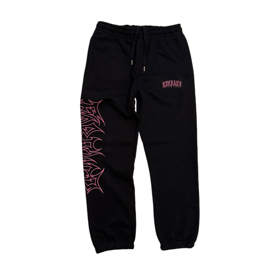 Black cuffed joggers with pink old English style lettering reading “KINSANE” on the right side and pink tribal outlined lettering reading “FOREVER” on the left side 