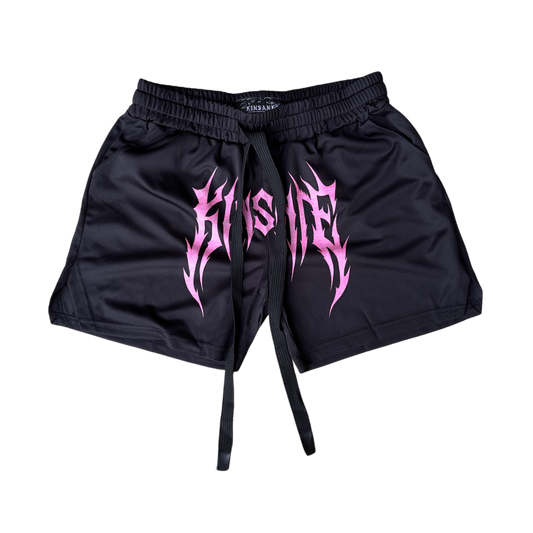 Black athletic shorts with pink tribal text on the front reading “KINSANE” 