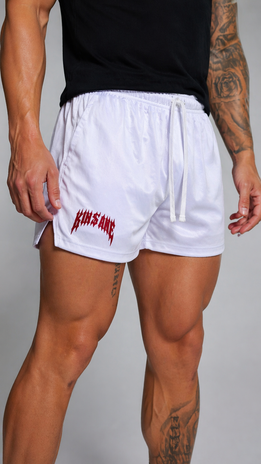Man wearing White athletic shorts with white drawstrings and red lettering on the right leg reading “KINSANE” 