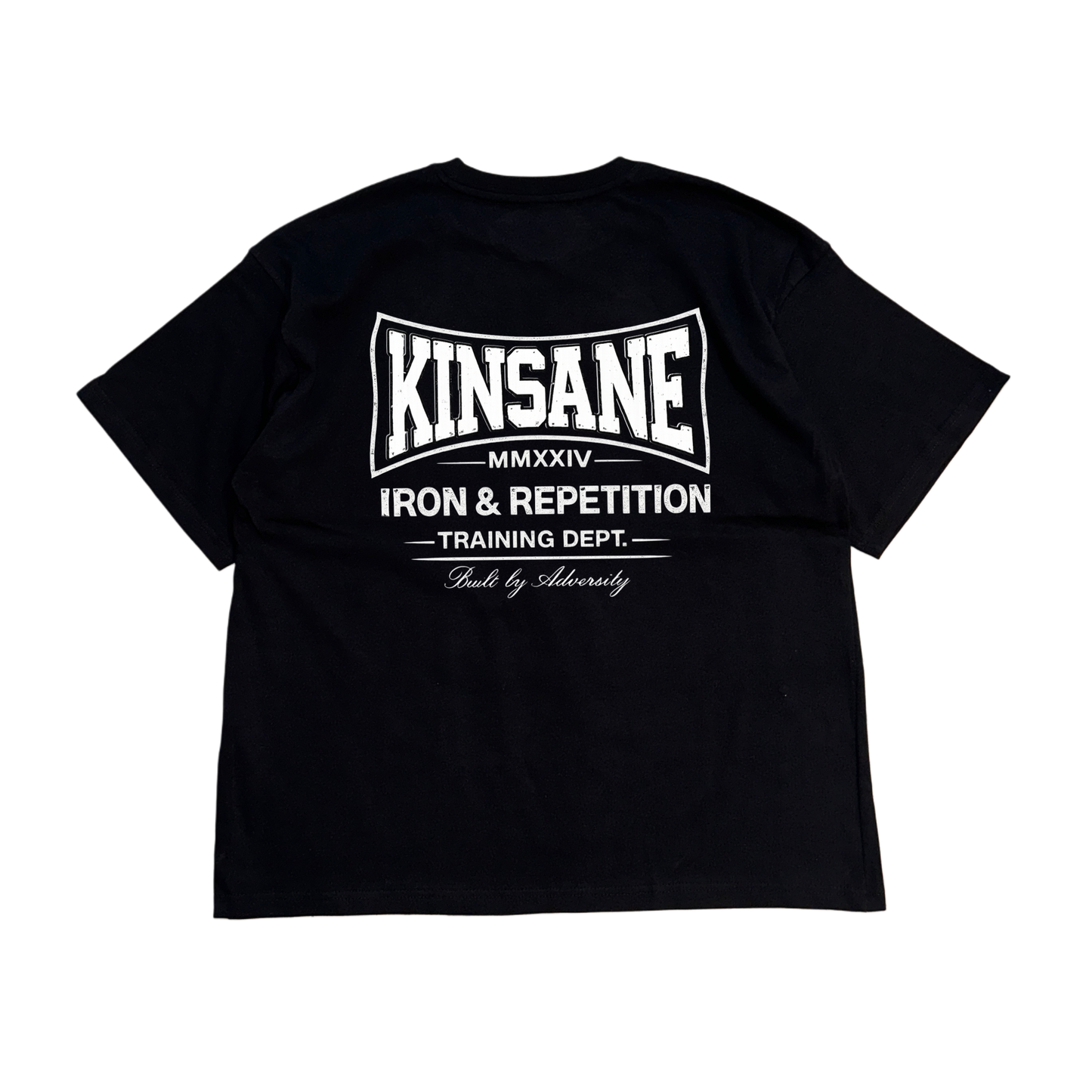 Back view of a black t shirt with white logo and white text reading “KINSANE MMXXIV IRON & REPETITION TRAINING DEPT. BUILT BY ADVERSITY” 