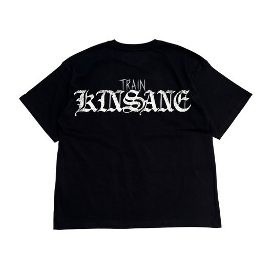 Back view of a black t shirt with white text reading “TRAIN KINSANE” 