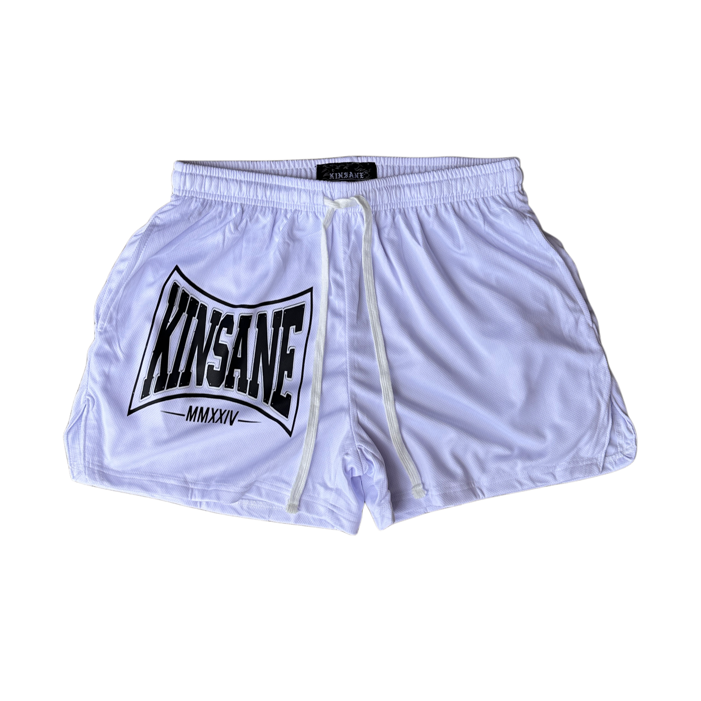 White athletic shorts with white drawstrings and a black logo on the left side with text reading “KINSANE MMXXIV” 
