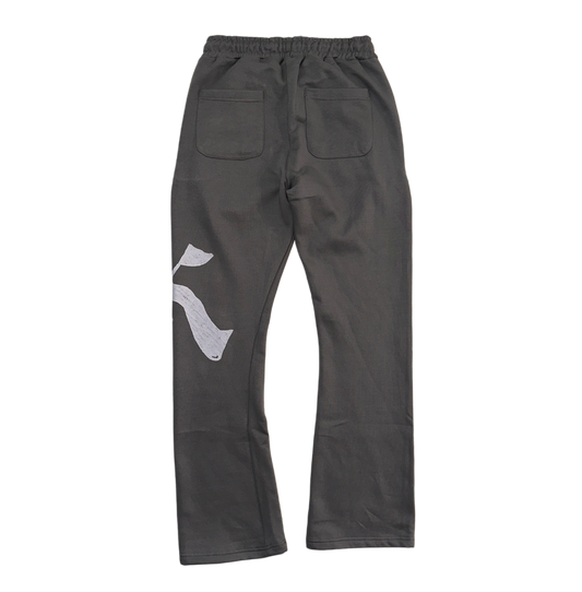 Back view of Gray stacked sweatpants with gray drawstrings and a white logo of a “K” on the left leg