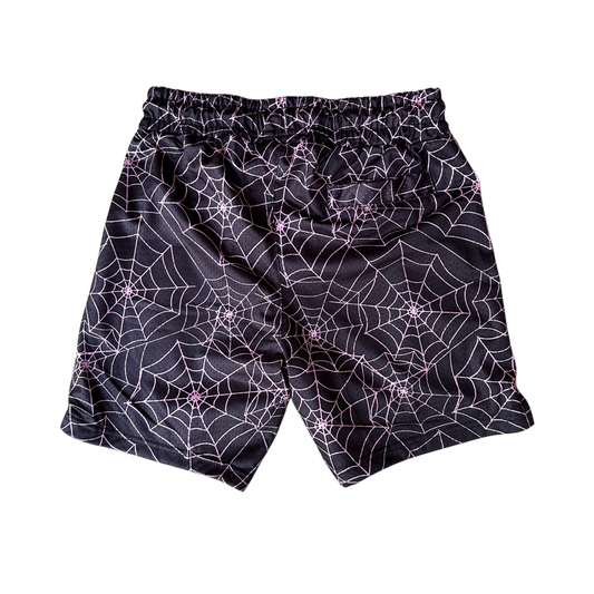 Back view of black shorts with pink web designs 