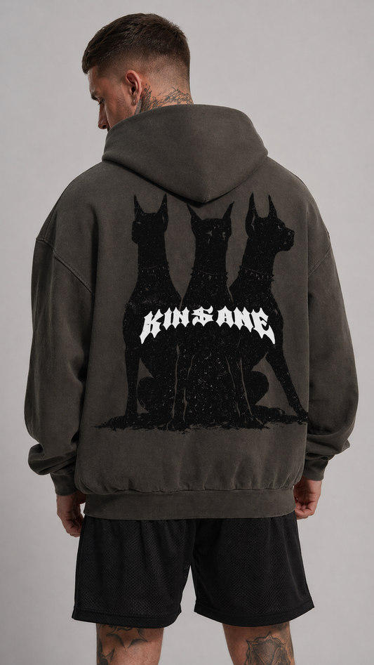 Back view of a man wearing a vintage gray hoodie with black Dobermans design and white text reading “KINSANE” 