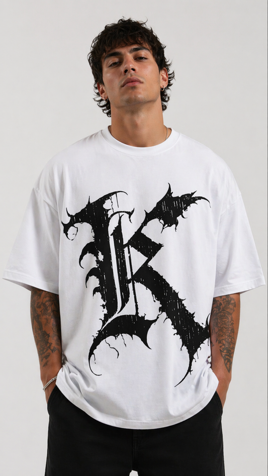 Man wearing White t shirt with black letter “K” on the front 