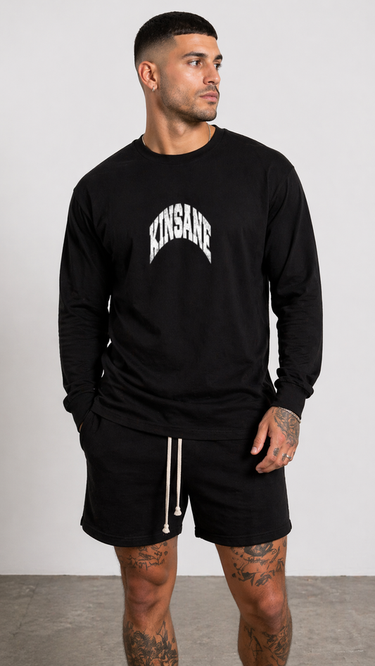 Man wearing a Black long sleeve shirt with white text reading “KINSANE” 