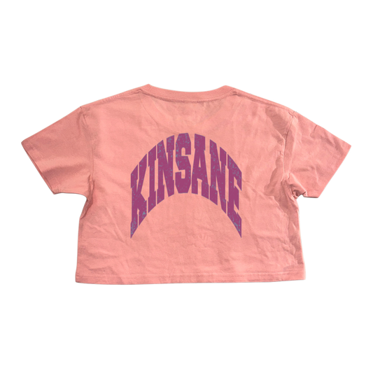 Back view of pink cropped top t shirt with purple text reading “KINSANE” 