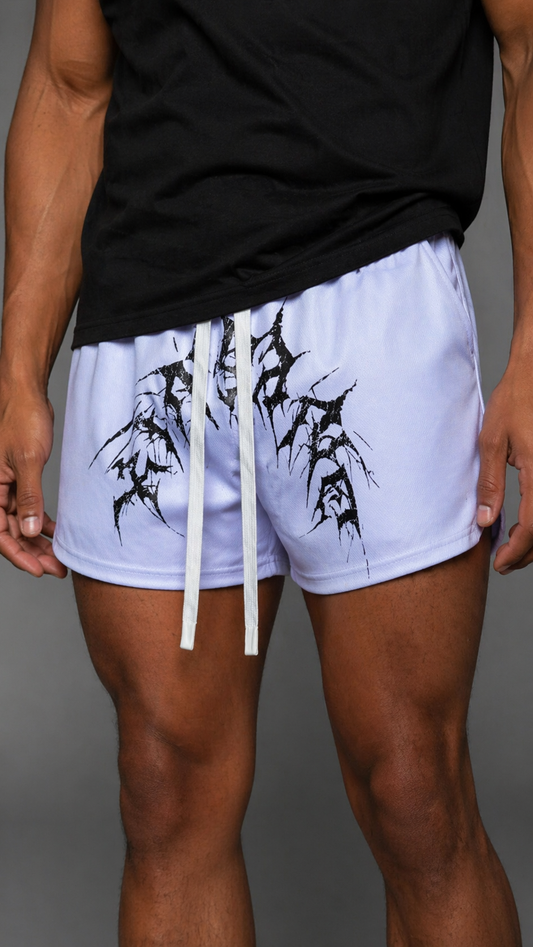 Man wearing White athletic shorts with elastic waistband and white drawstrings with black tribal lettering reading “KINSANE” across the middle 