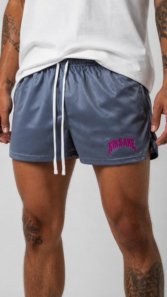 Man wearing Grey athletic shorts with white drawstrings and red text reading “KINSANE” on the left leg 
