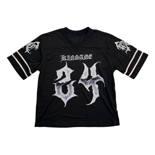Black jersey with white numbers “24” and white tribal lettering reading “KINSANE” and white logos on each sleeve 